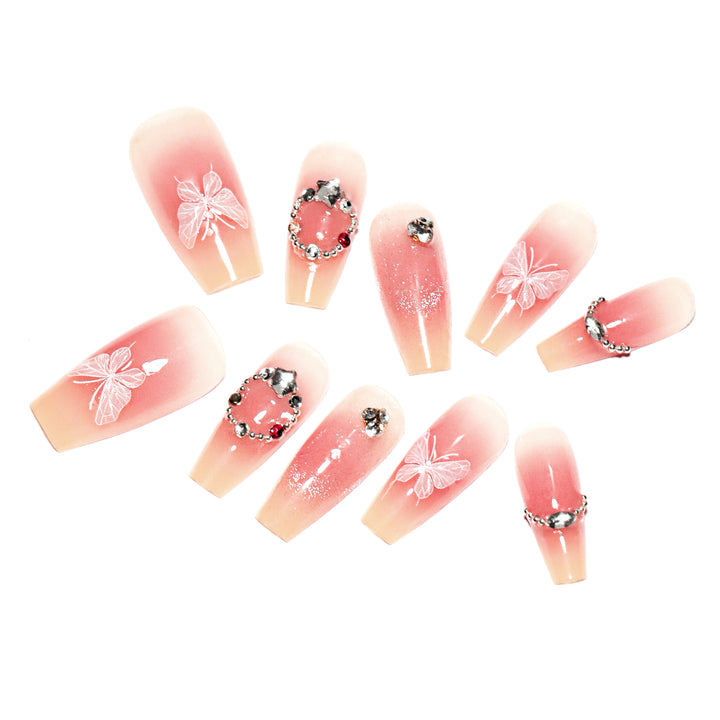Artificial nail extensions with floral design and sparkling accents Stornfield