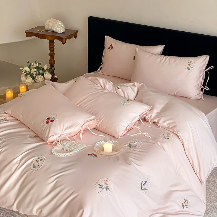 Luxurious cotton satin bedding set with delicate floral embroidery and ties