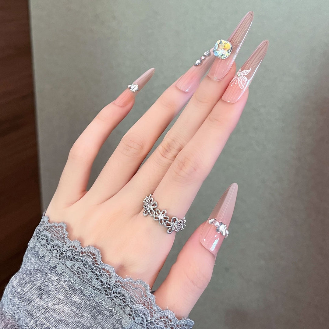 Artistic Stiletto Press-On Nail Art with Glimmering Accents Stornfield