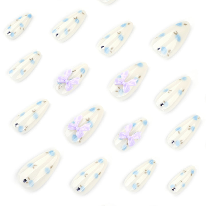 Artful stiletto nails with delicate flower patterns and glitter accents Stornfield