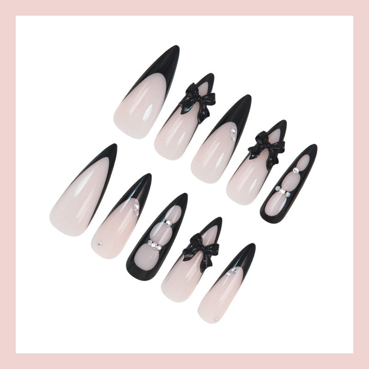 Acrylic nail set with shimmering accents and elegant bows Stornfield