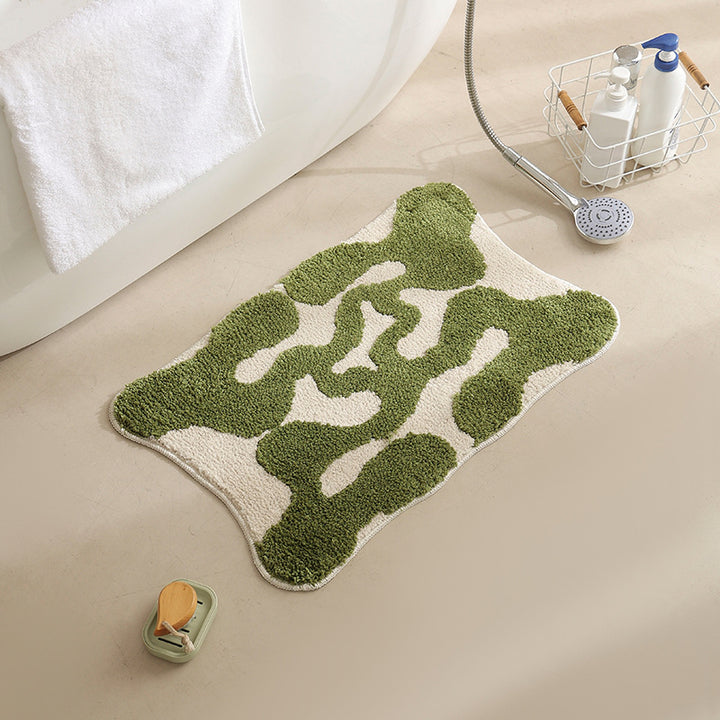 Hand-tufted bathroom bath mat with non-slip backing and textured square relief Stornfield