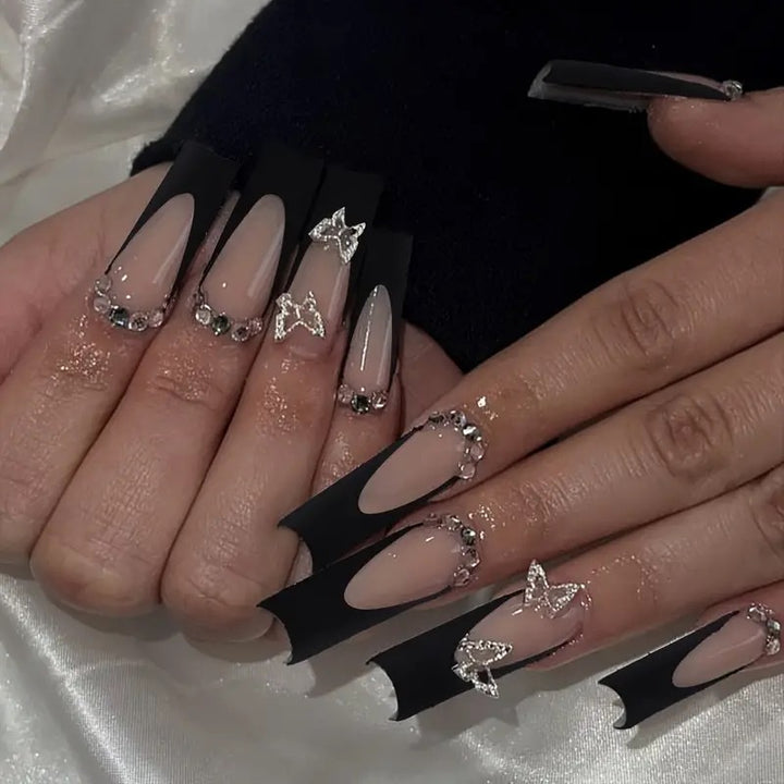 Trendy artificial nails with delicate rhinestone and butterfly accents Stornfield