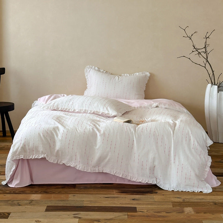 Bedding set made of lightweight cotton muslin with fine line embroidery and ruffled border
