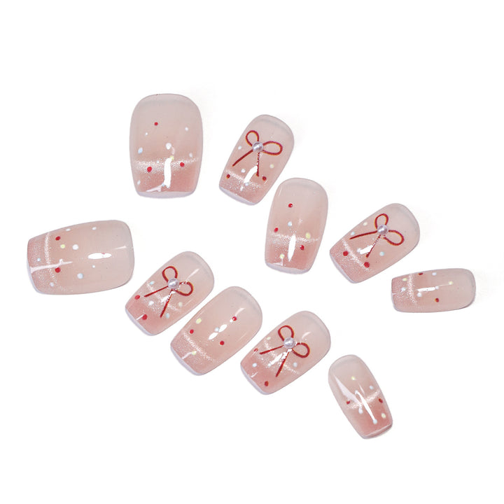 Artificial nail art with elegant bows and glitter accents Stornfield