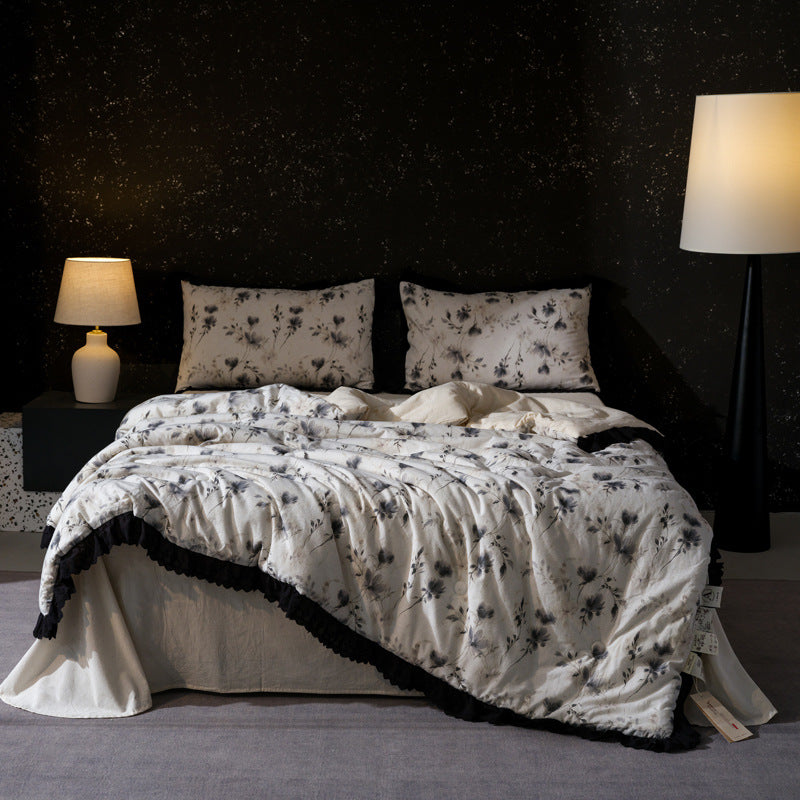 Bedding set made of cotton blend with subtle floral stitching pattern and lace border