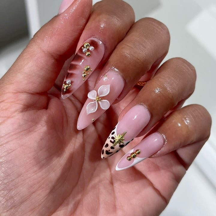 Acrylic nail set with glamorous accents and floral decorations Stornfield