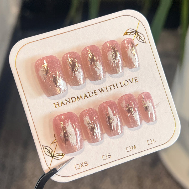 Artificial nail extensions with elegant gold design Stornfield