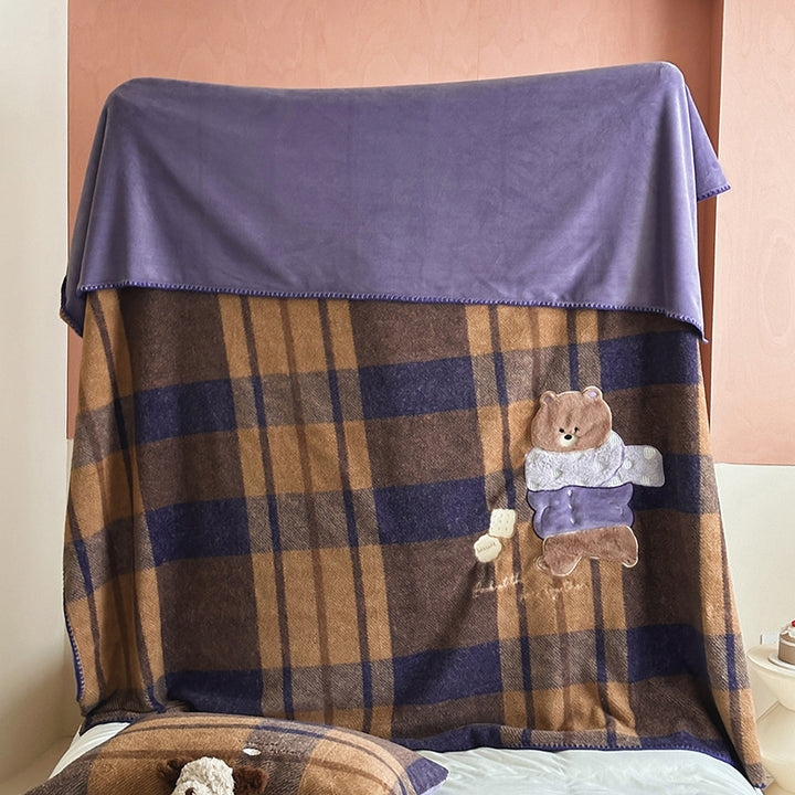 Plaid blanket checkered with appliqued animal motifs and soft velour lining