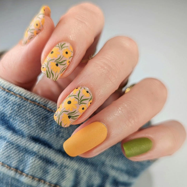 Artistic nail extensions with floral designs and creative color accents Stornfield