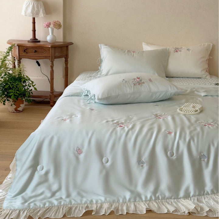 Romantic satin bedding set with ruffle, floral embroidery and tie pillow