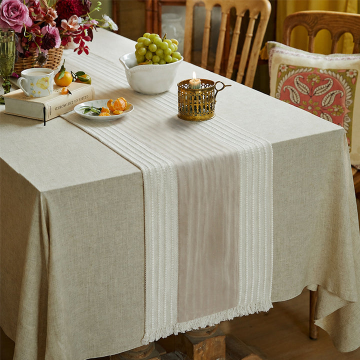 Woven table runner with contrasting center stripe, textured waffle look and decorative fringes