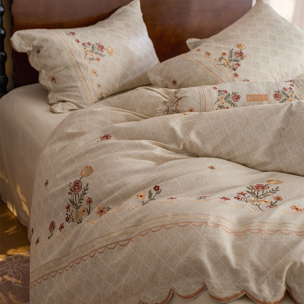 Luxurious embroidered cotton bedding set with ruffle and decorative pillow