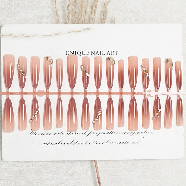 Artificial nail set with elegant ombre effect and glamorous embellishments Stornfield