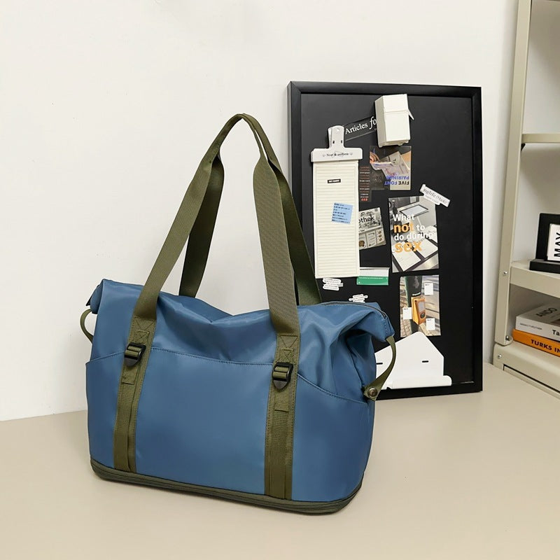 Sporty shoulder bag with water-repellent material and sturdy carrying handles Stornfield