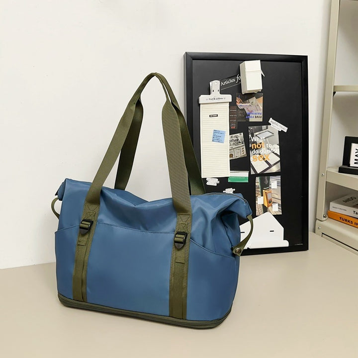 Sporty shoulder bag with water-repellent material and sturdy carrying handles Stornfield