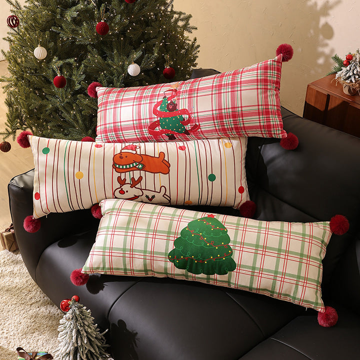 Long decorative lumbar and neck pillow in Christmas check with pompom and dog-tree motif Stornfield