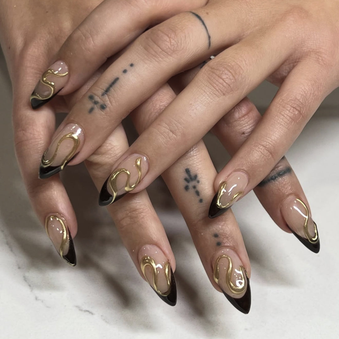 Artful stiletto nails with elegant gold design Stornfield