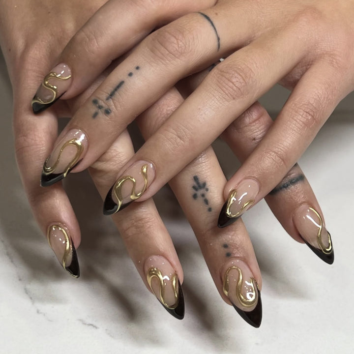 Artful stiletto nails with elegant gold design Stornfield