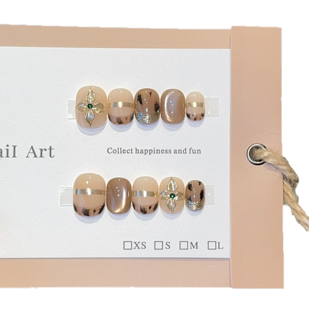 Artificial nails with elegant gold embellishments Stornfield