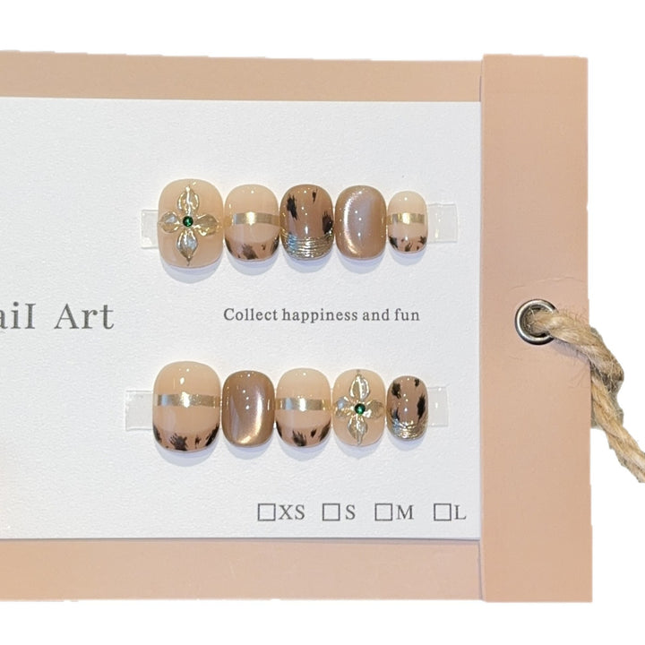 Artificial nails with elegant gold embellishments Stornfield