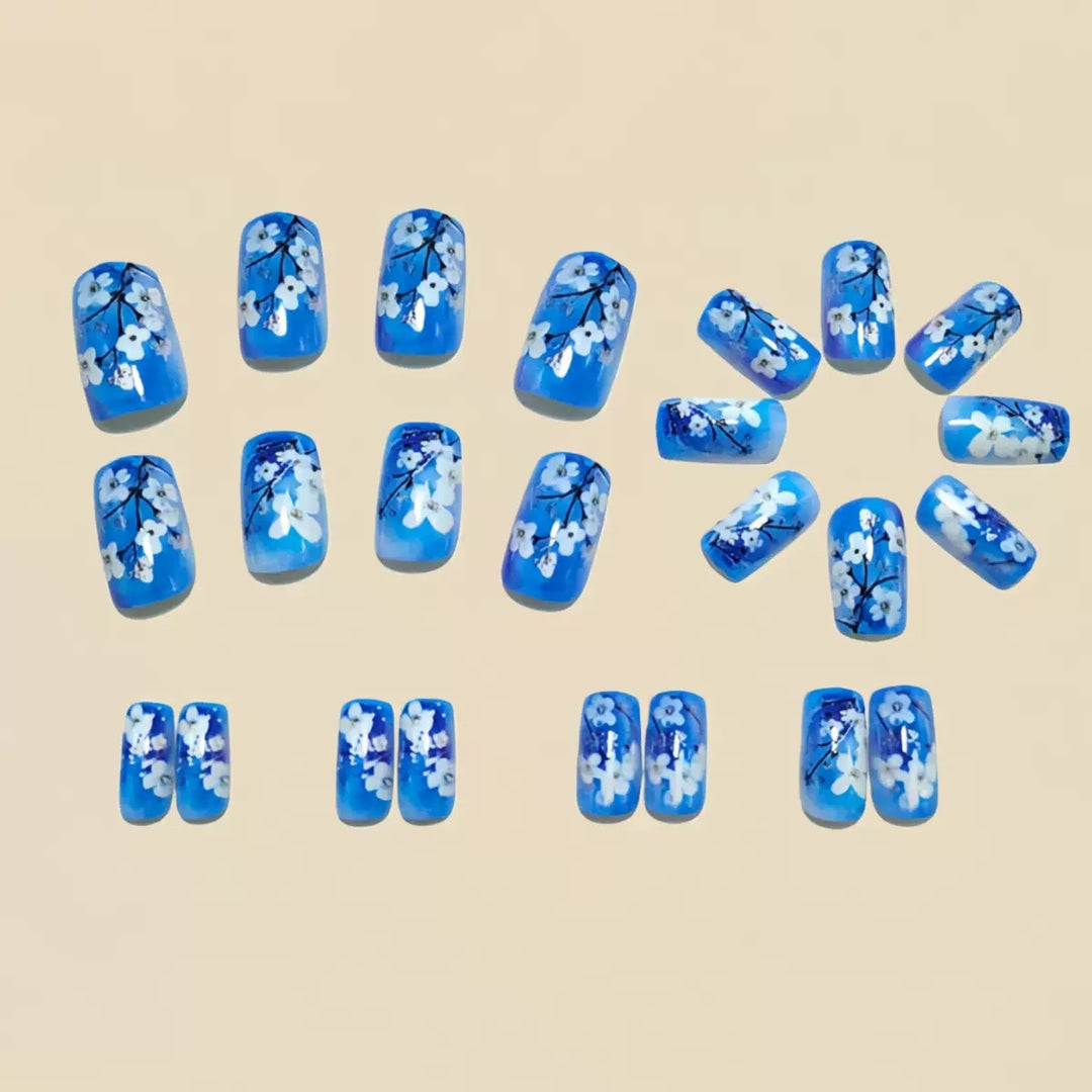 Artificial nail set with floral designs and glitter accents Stornfield
