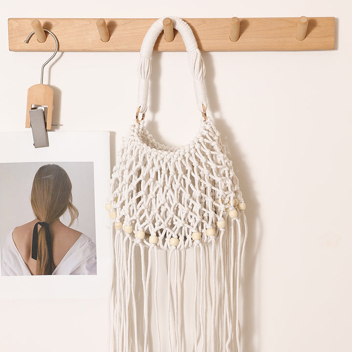 Macrame bag with decorative fringes and wooden beads Stornfield