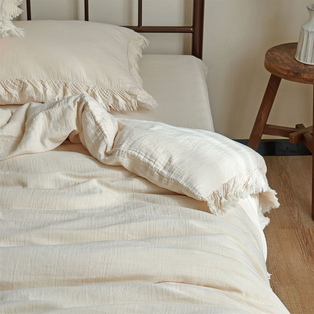 Washed linen bedding set with fringe trim and natural texture