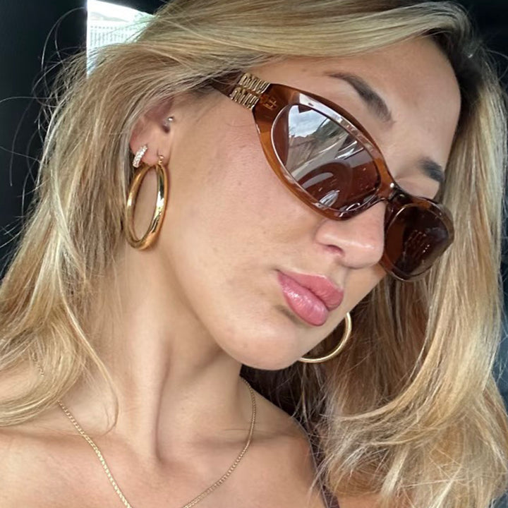 Women’s fashionable sunglasses in a curved design with luxurious details Stornfield