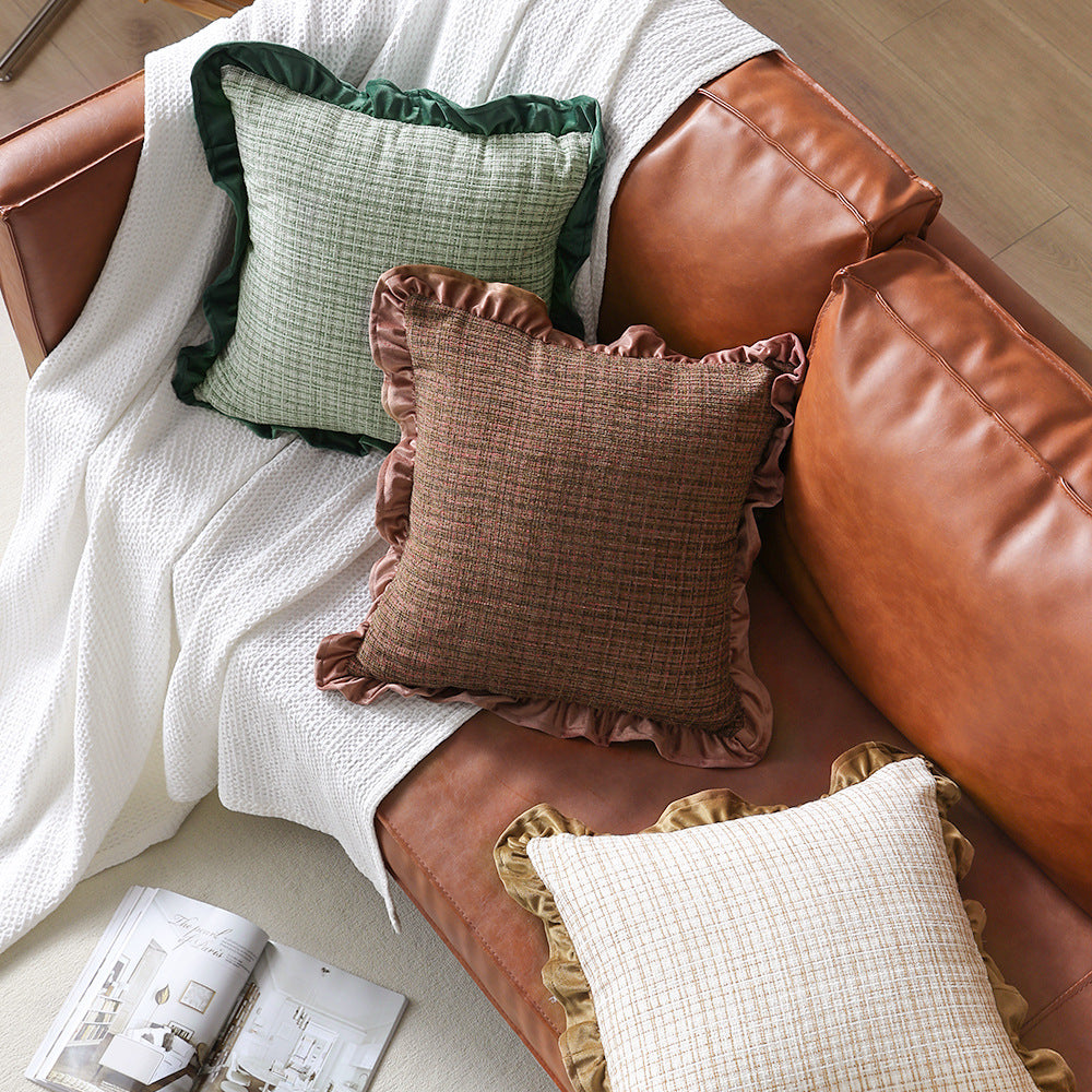 Square decorative pillow with woven linen texture and decorative ruffled edge