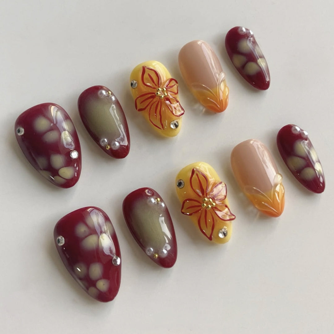 Artificial nail extensions with floral design and rhinestone embellishments Stornfield