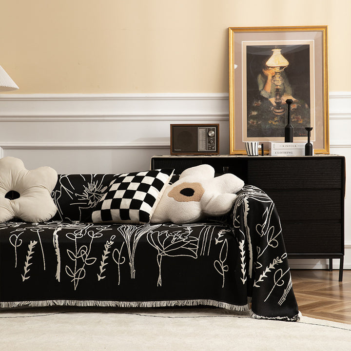 Light woven sofa cover with botanical line print and fringe hem