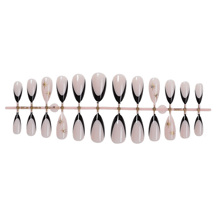 Artificial nail set with elegant black-and-white design and golden star accents Stornfield
