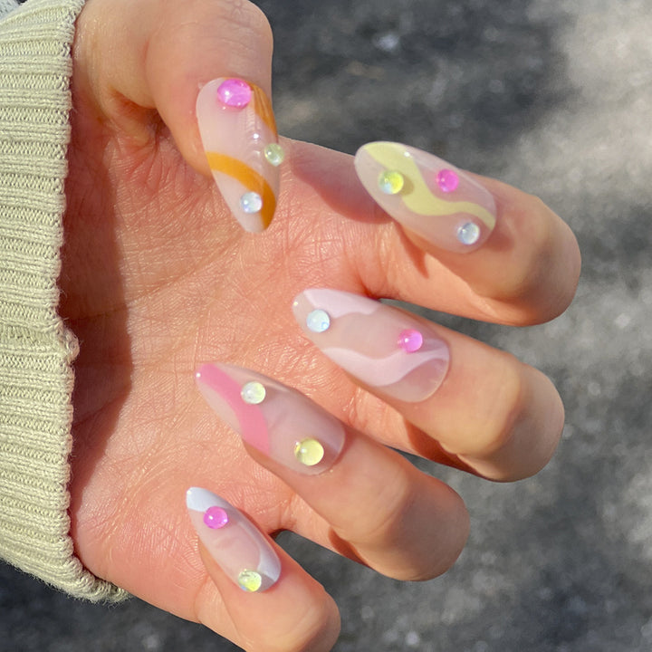 Artistic Nail Extensions with Colorful Design and Glitter Accents Stornfield