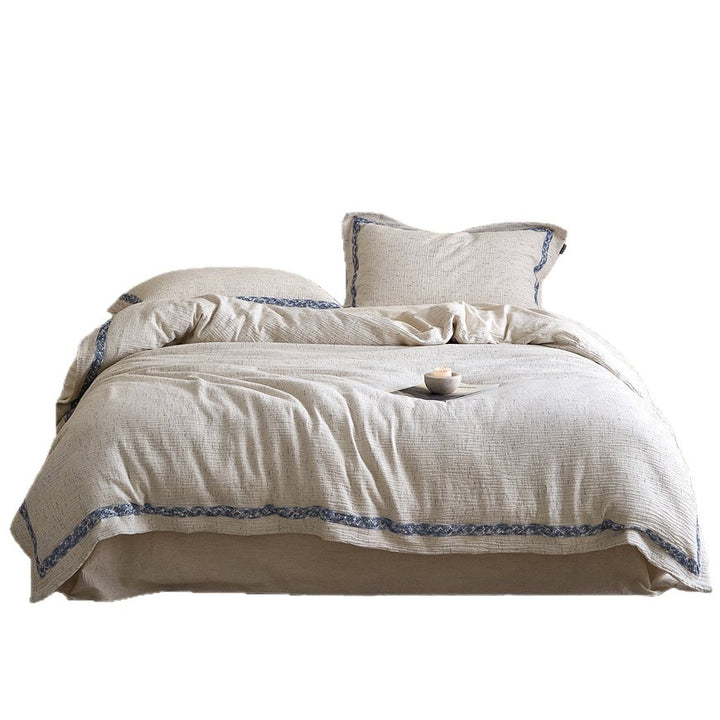 Linen bedding set with woven texture and subtle indigo border