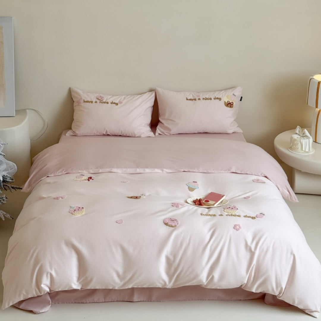 Quilted bedding set with cupcake embroideries and text application