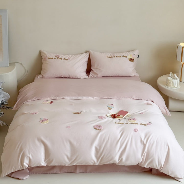 Quilted bedding set with cupcake embroideries and text application