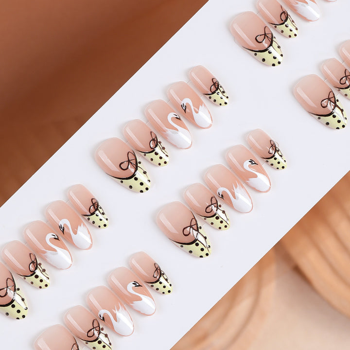 Art nail set with creative swan design and playful dots Stornfield