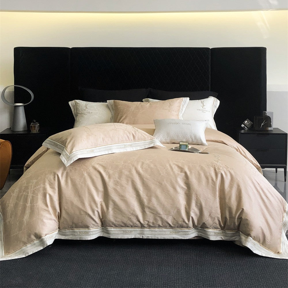 Luxurious satin bedding set with subtle marble texture and golden embroidered border