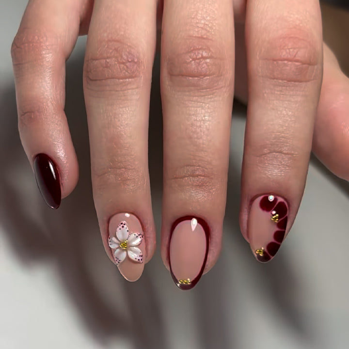 Acrylic nail set with elegant floral patterns and glamour accents Stornfield