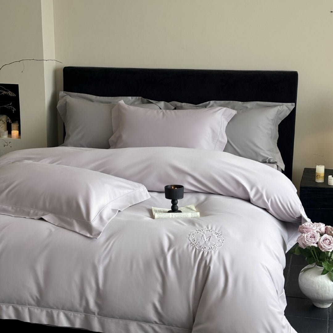 Luxurious cotton satin bedding set with monogram embroidery and fine piping