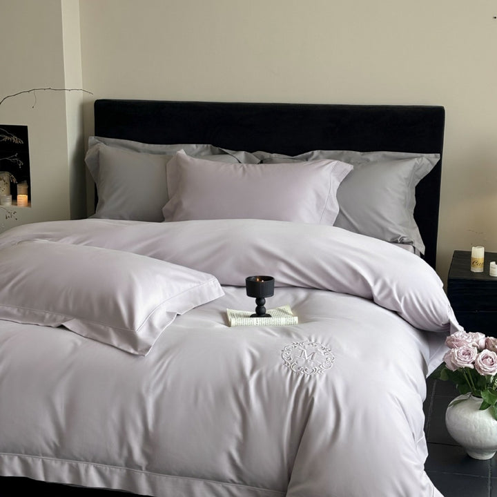 Luxurious cotton satin bedding set with monogram embroidery and fine piping
