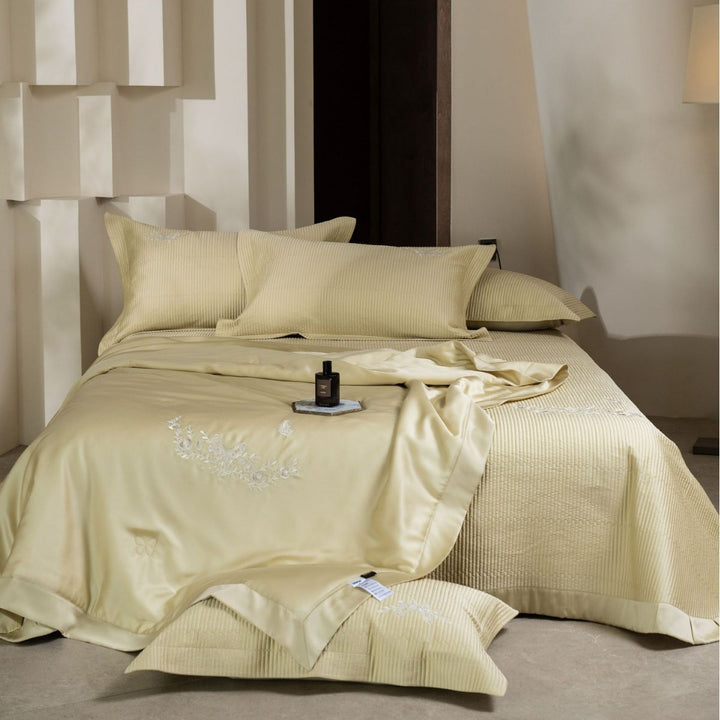 Luxurious cotton satin bedding set with quilted bedspread and floral embroidery