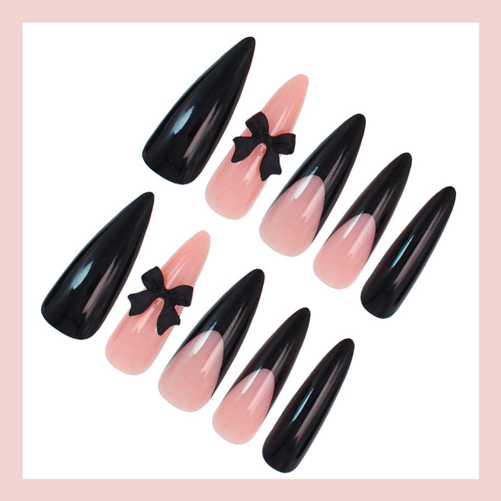 Acrylic nail set with elegant black-and-white design and playful accents Stornfield