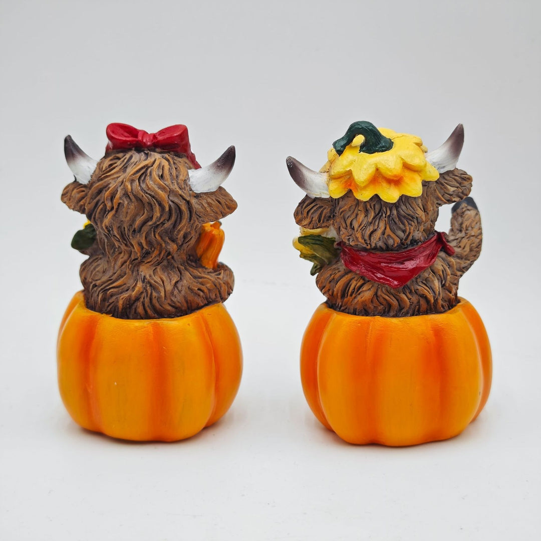 Funny decorative figure of a Highland cow in pumpkin costume Stornfield