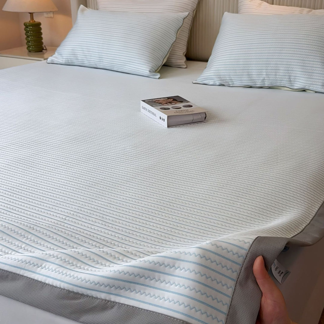 Striped fitted sheet and pillowcase set made of breathable cotton blend with fine zigzag quilting