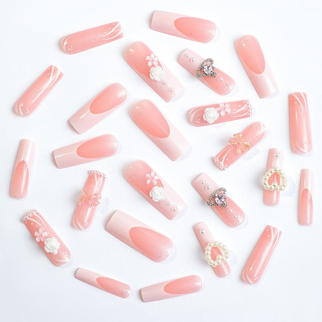 Elegant artificial nail set with glitter and floral accents Stornfield