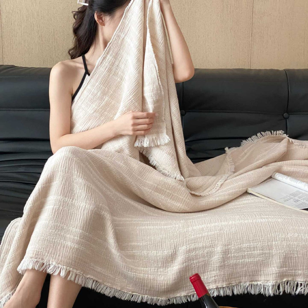 Cozy living blanket made of cotton blend fabric with fringes and striped texture
