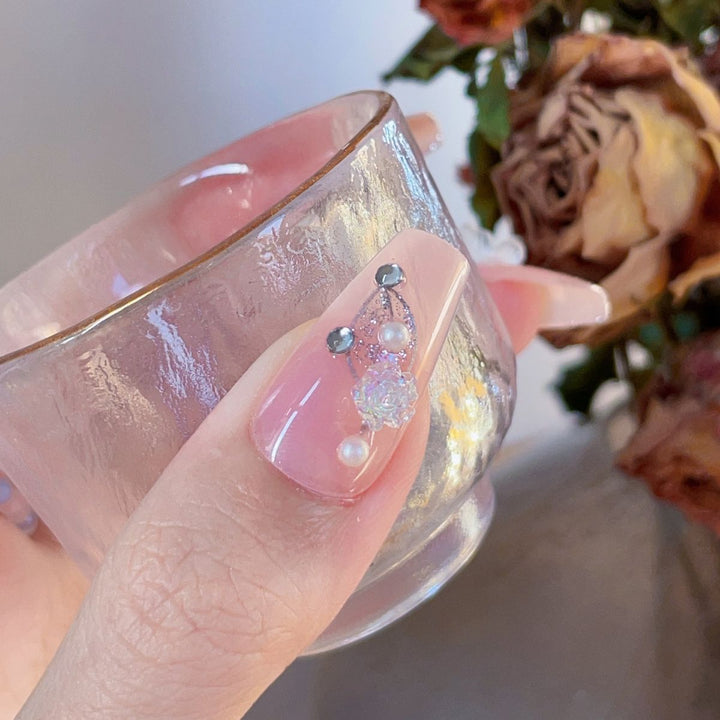 Artificial nails with glamorous pearl and glitter design Stornfield