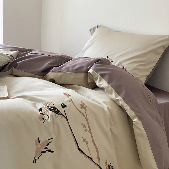 Reversible cotton satin bed set with finely embroidered bird and branch motifs